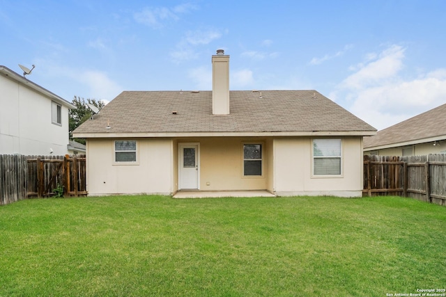 rear view of house featuring a lawn and a patio