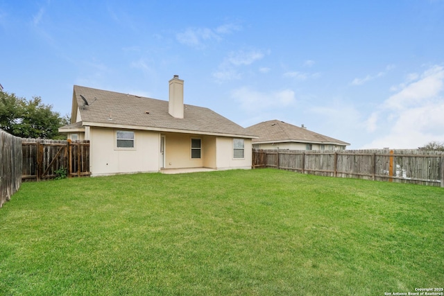 rear view of property with a lawn