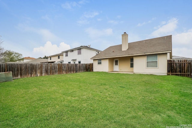 rear view of house with a yard