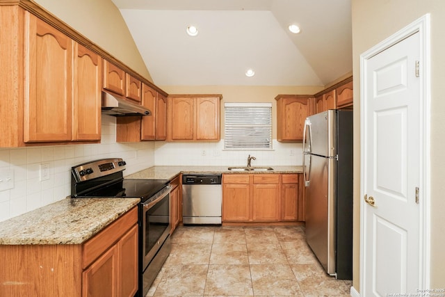 kitchen featuring light stone countertops, appliances with stainless steel finishes, sink, backsplash, and vaulted ceiling