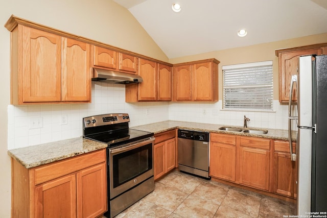 kitchen with sink, backsplash, light stone countertops, lofted ceiling, and stainless steel appliances