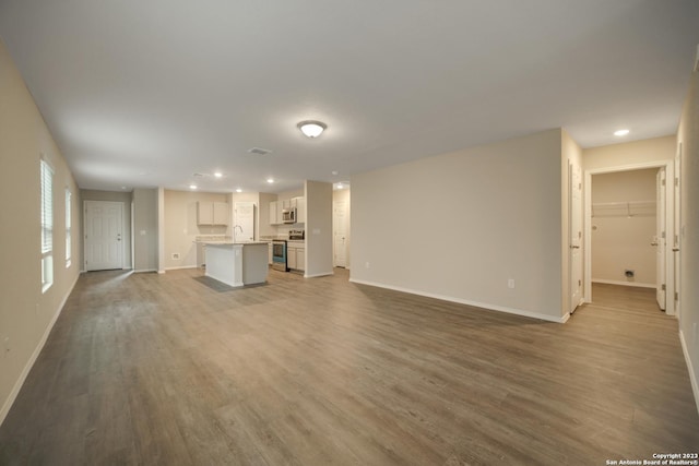 3411 Mccrae Xing, San Antonio, TX 78264 - unfurnished living room featuring hardwood / wood-style flooring