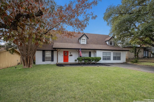 cape cod-style house with a front lawn