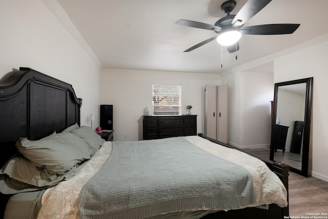 bedroom with dark wood-type flooring and ceiling fan