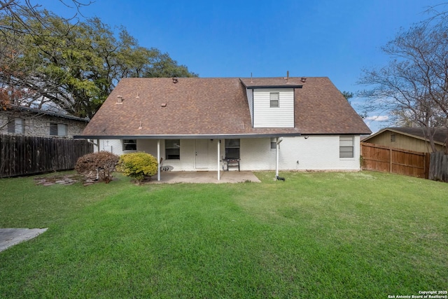 back of property featuring a patio area and a yard