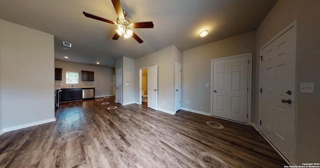 unfurnished living room with sink, ceiling fan, and dark hardwood / wood-style floors