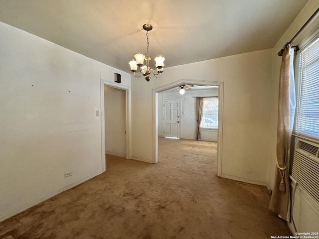 unfurnished dining area featuring a chandelier and light carpet