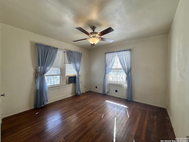 spare room featuring ceiling fan and dark hardwood / wood-style floors