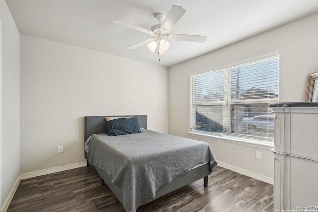 bedroom with ceiling fan and dark hardwood / wood-style floors