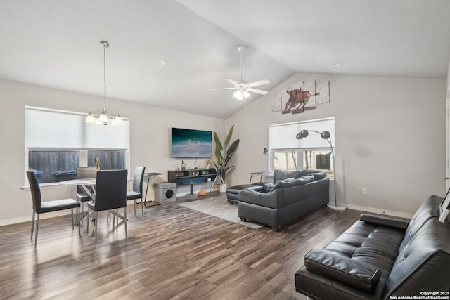 living room with vaulted ceiling, ceiling fan with notable chandelier, and hardwood / wood-style floors