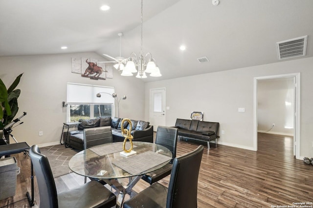 dining space featuring vaulted ceiling, an inviting chandelier, and dark hardwood / wood-style flooring