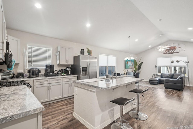 kitchen with stainless steel fridge with ice dispenser, a center island, and white cabinets