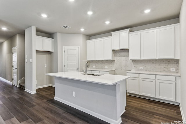 11559 Cottage Pt, San Antonio, TX 78254 - kitchen with white cabinetry, sink, dark wood-type flooring, and an island with sink