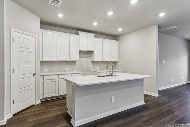 11559 Cottage Pt, San Antonio, TX 78254 - kitchen featuring dark wood-type flooring, sink, white cabinetry, tasteful backsplash, and a kitchen island with sink