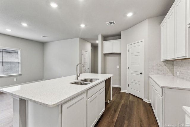 11559 Cottage Pt, San Antonio, TX 78254 - kitchen featuring sink, dark wood-type flooring, an island with sink, white cabinets, and decorative backsplash