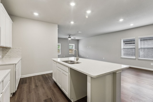 11559 Cottage Pt, San Antonio, TX 78254 - kitchen featuring a kitchen island with sink, sink, dark hardwood / wood-style floors, and white cabinets