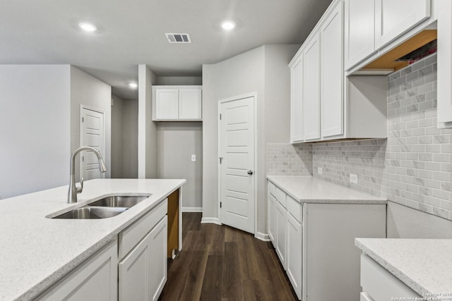 11559 Cottage Pt, San Antonio, TX 78254 - kitchen featuring sink, dark hardwood / wood-style floors, light stone countertops, decorative backsplash, and white cabinets