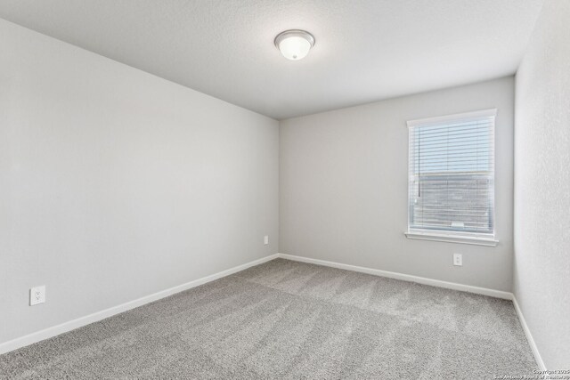 11559 Cottage Pt, San Antonio, TX 78254 - spare room with a textured ceiling and carpet