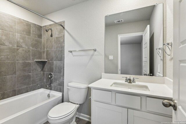 11559 Cottage Pt, San Antonio, TX 78254 - full bathroom featuring tiled shower / bath, vanity, and toilet