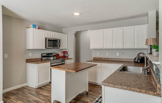 kitchen featuring sink, white cabinets, dark hardwood / wood-style flooring, and stainless steel appliances