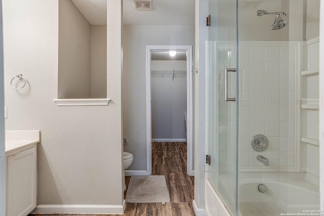 bathroom with hardwood / wood-style flooring, toilet, and vanity