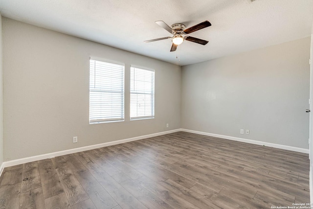 unfurnished room featuring ceiling fan, dark hardwood / wood-style floors, and a textured ceiling