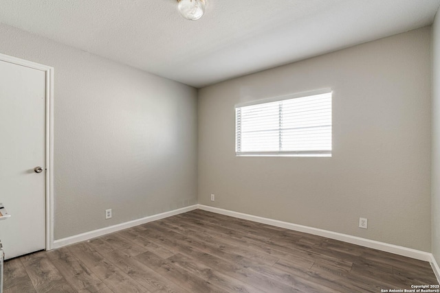 spare room with dark wood-type flooring