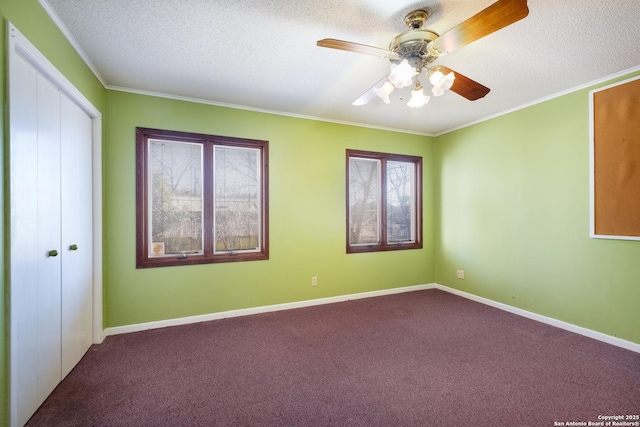 unfurnished bedroom featuring carpet flooring, ornamental molding, ceiling fan, a textured ceiling, and a closet