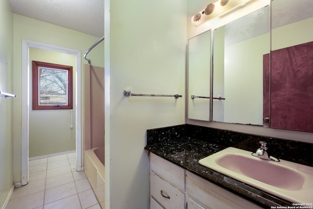 bathroom featuring vanity, tile patterned flooring, shower / washtub combination, and a textured ceiling