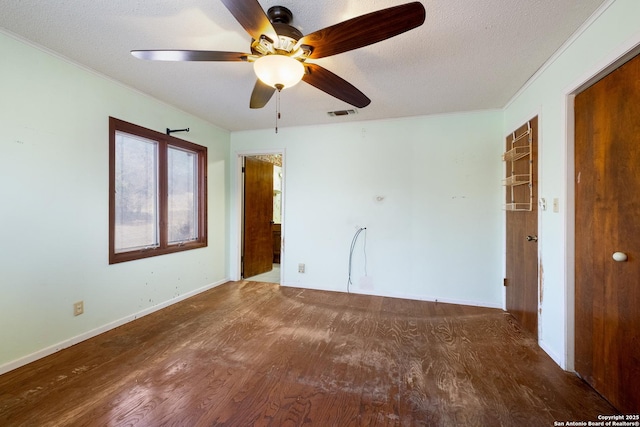 unfurnished bedroom featuring ceiling fan, dark hardwood / wood-style flooring, and a textured ceiling