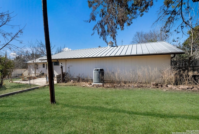 view of home's exterior featuring central AC and a lawn