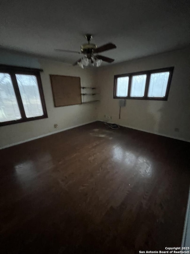 spare room with hardwood / wood-style flooring and ceiling fan