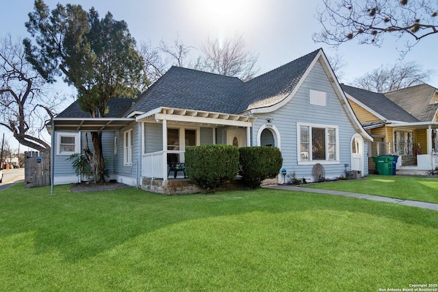 view of front of home featuring covered porch and a front lawn