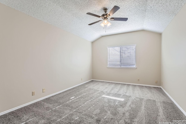 carpeted empty room with ceiling fan, a textured ceiling, and lofted ceiling