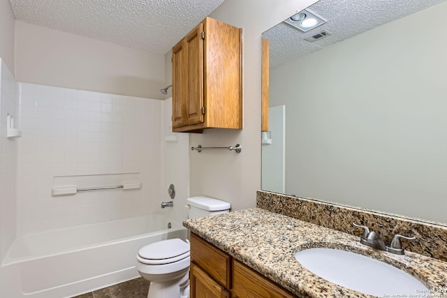 full bathroom featuring a textured ceiling, bathing tub / shower combination, tile patterned floors, vanity, and toilet