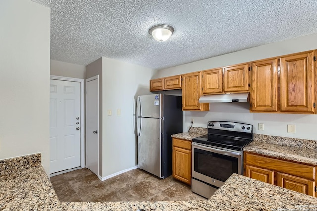 kitchen with light stone counters, a textured ceiling, and appliances with stainless steel finishes