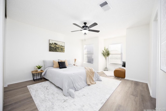 bedroom featuring ceiling fan and hardwood / wood-style flooring