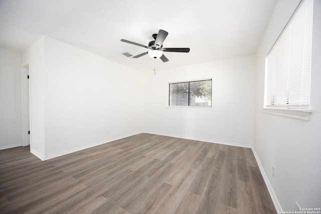 spare room with hardwood / wood-style flooring and ceiling fan