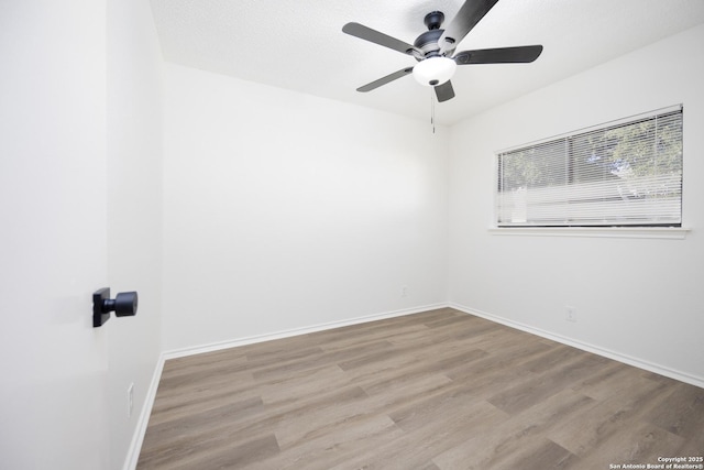 unfurnished room featuring ceiling fan and light wood-type flooring