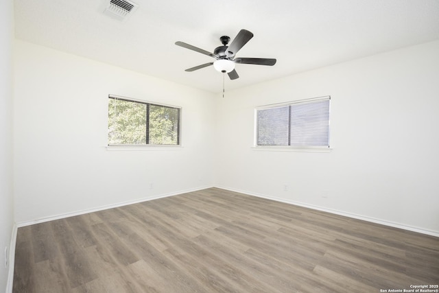 spare room with ceiling fan and hardwood / wood-style floors