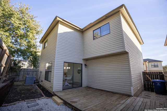 rear view of house with a deck and central AC unit