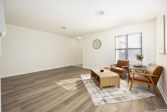 sitting room with dark wood-type flooring