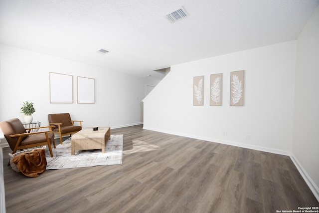 sitting room with hardwood / wood-style floors and a textured ceiling