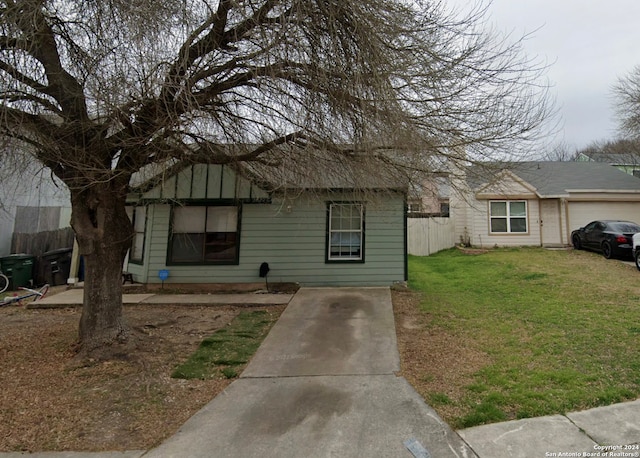 view of front of home with a front yard and a garage