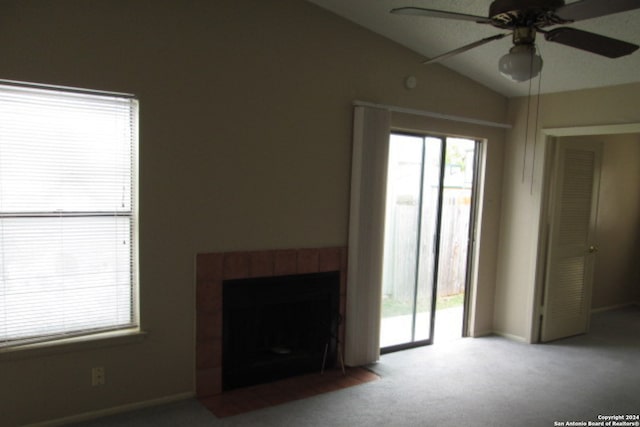 unfurnished living room with a fireplace, carpet floors, lofted ceiling, and ceiling fan