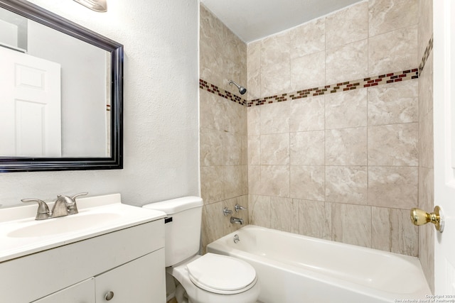 full bathroom featuring toilet, vanity, and tiled shower / bath