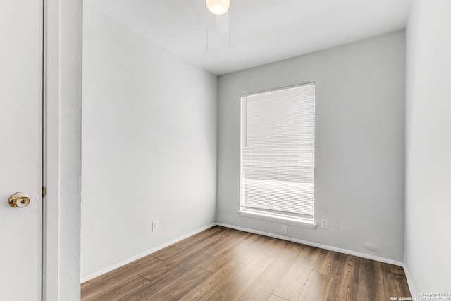 empty room with hardwood / wood-style flooring and ceiling fan