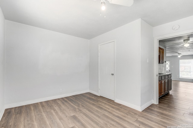 spare room featuring light wood-type flooring and ceiling fan