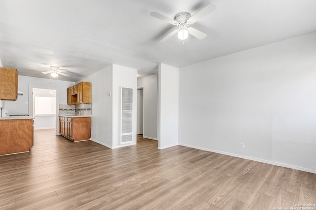 unfurnished living room featuring light hardwood / wood-style floors and ceiling fan