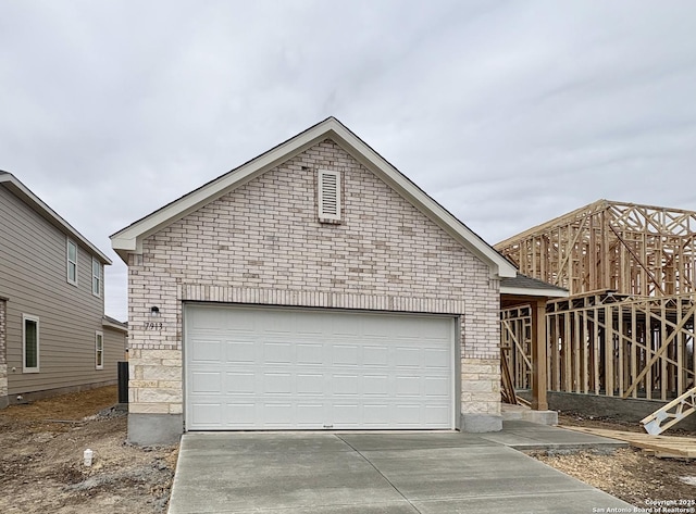 view of front of property with an outdoor structure and a garage